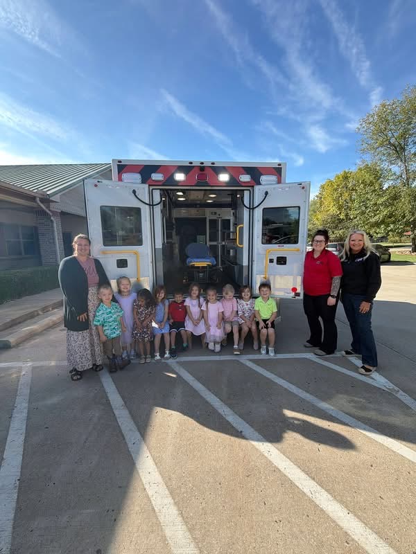 Amaze Academy children and teachers meeting local paramedics