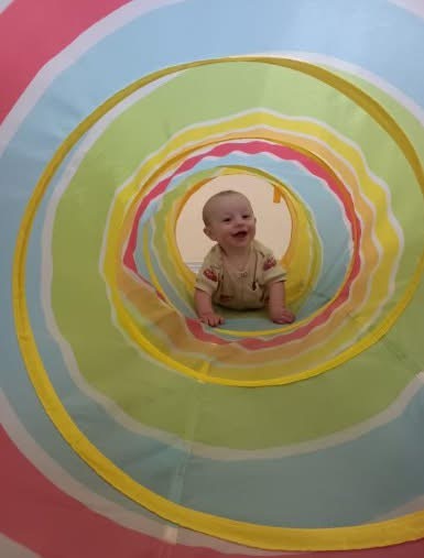 A child exploring a colorful classroom activity